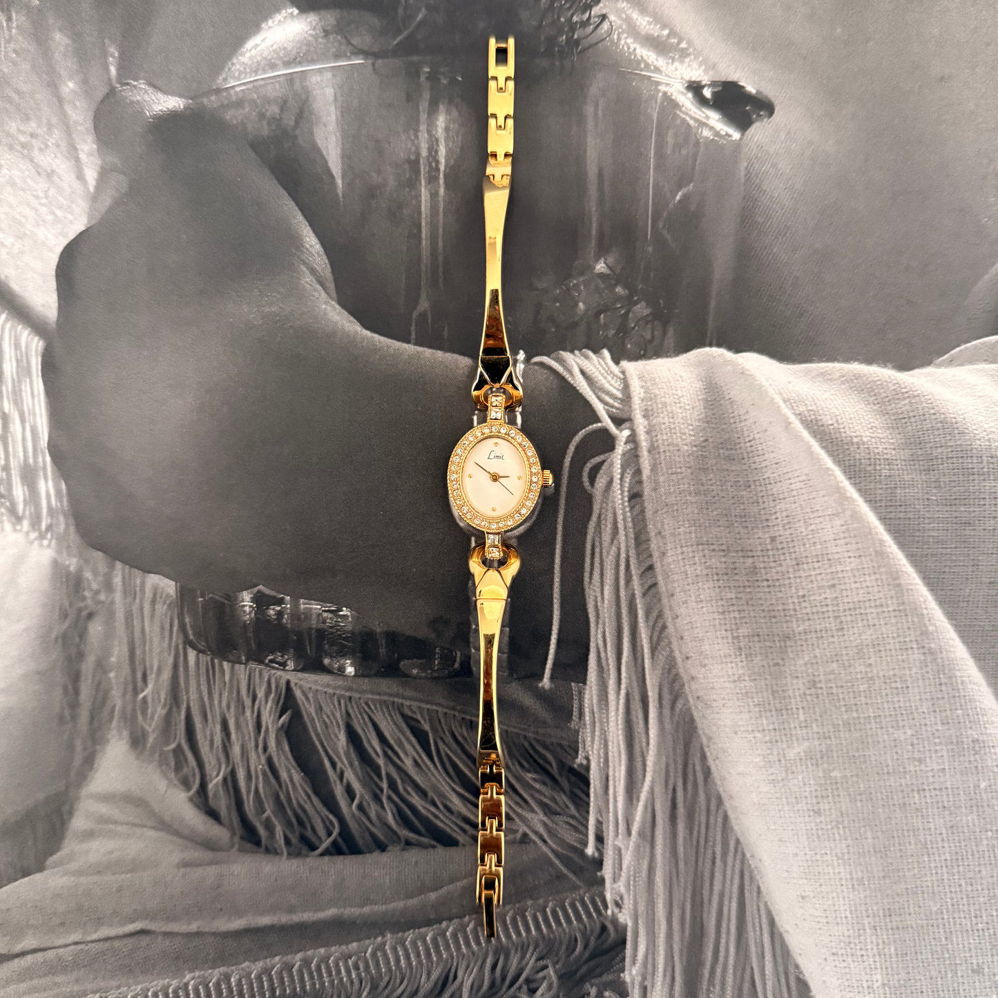 Gold circle face gemmed cuff bracelet watch