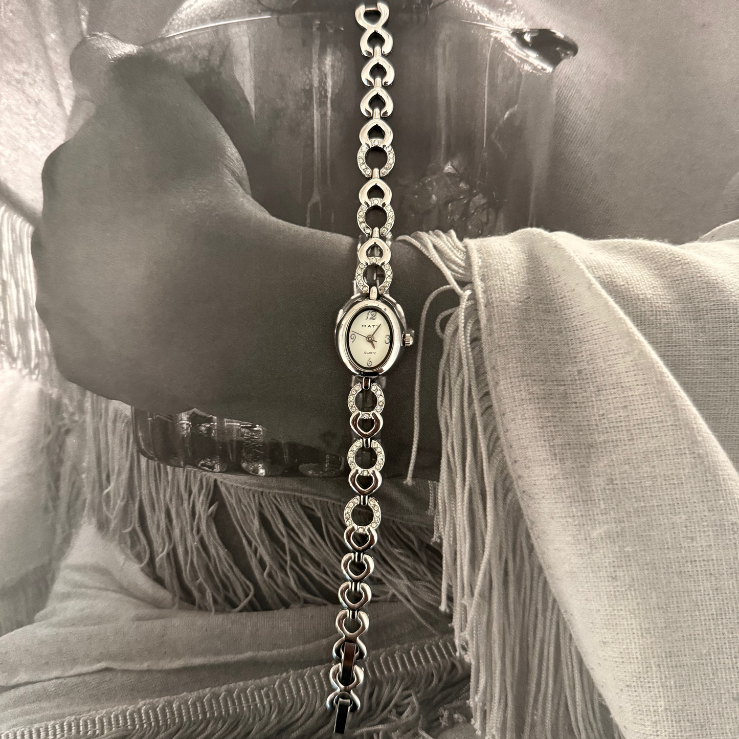 Silver oval face gemmed link band watch