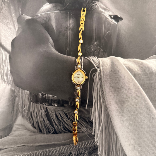 Gold oval face gemmed band watch
