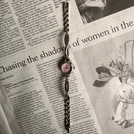 Silver oval pink face twist gemmed band watch